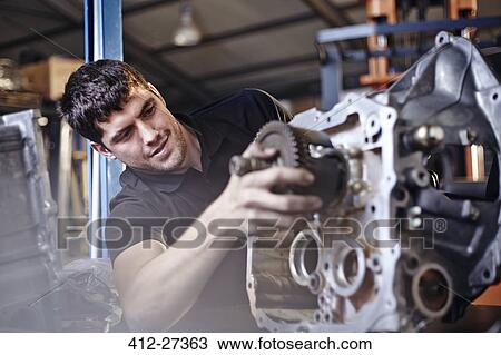 Mechanic fixing part in auto repair shop View Large Photo Image Stock Image - Mechanic fixing part in auto repair shop. Fotosearch