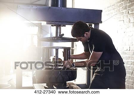Mechanic using tire changer machine in auto repair shop View Large Photo Image Stock Image - Mechanic using tire changer machine in auto repair shop. Fotosearch