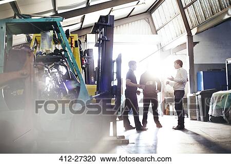 Mechanics and manager talking in auto repair shop View Large Photo Image Stock Image - Mechanics and manager talking in auto repair shop. Fotosearch