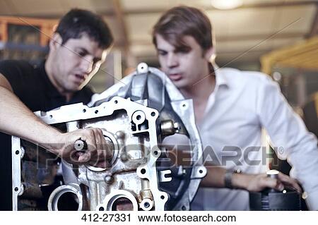 Mechanics examining part in auto repair shop View Large Photo Image Stock Image - Mechanics examining part in auto repair shop. Fotosearch