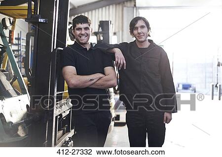 Portrait confident mechanics in auto repair shop View Large Photo Image Stock Image - Portrait confident mechanics in auto repair shop. Fotosearch