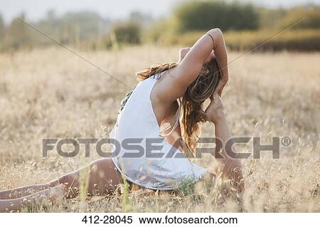 Boho woman in royal king pigeon pose in sunny rural field View Large Photo Image Stock Photography - Boho woman in royal king pigeon pose in sunny rural field. Fotosearch