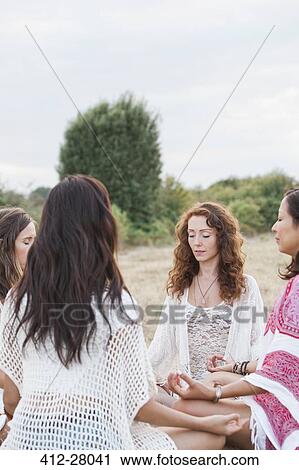 Boho women meditating in circle in rural field View Large Photo Image Stock Image - Boho women meditating in circle in rural field. Fotosearch