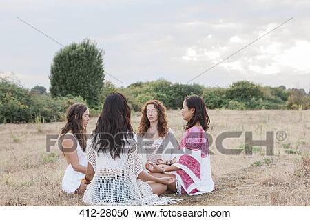 Boho women meditating in circle in rural field View Large Photo Image Stock Image - Boho women meditating in circle in rural field. Fotosearch