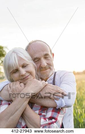 Close up portrait serene senior couple hugging with eyes closed View Large Photo Image Stock Image - Close up portrait serene senior couple hugging with eyes closed. Fotosearch