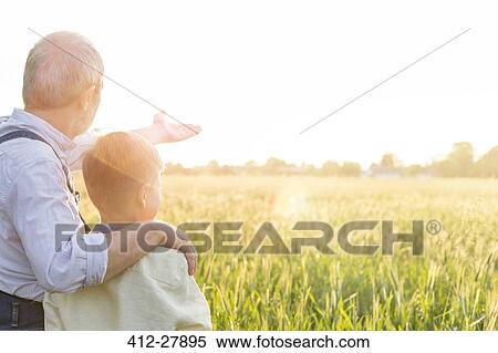 Grandfather farmer explaining rural wheat crop to grandson View Large Photo Image Stock Photography - Grandfather farmer explaining rural wheat crop to grandson. Fotosearch