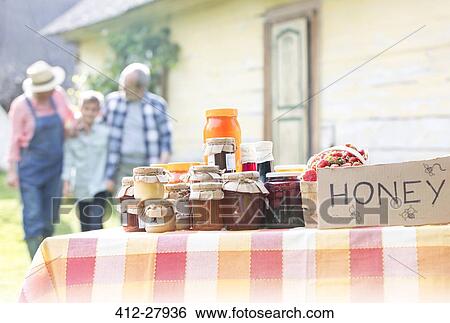 Stock Photograph - Grandparents and grandson walking toward honey stand. Fotosearch