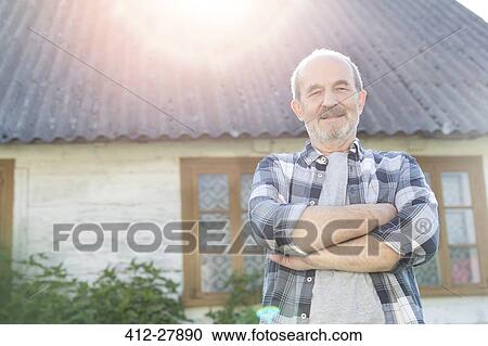 Portrait confident senior farmer outside farmhouse View Large Photo Image Stock Image - Portrait confident senior farmer outside farmhouse. Fotosearch
