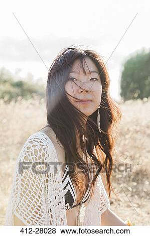Portrait serious boho woman in bikini in sunny field View Large Photo Image Stock Photo - Portrait serious boho woman in bikini in sunny field. Fotosearch
