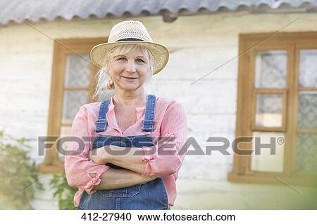 Portrait smiling farmer in overalls and straw hat outside farmhouse View Large Photo Image Stock Image - Portrait smiling farmer in overalls and straw hat outside farmhouse. Fotosearch
