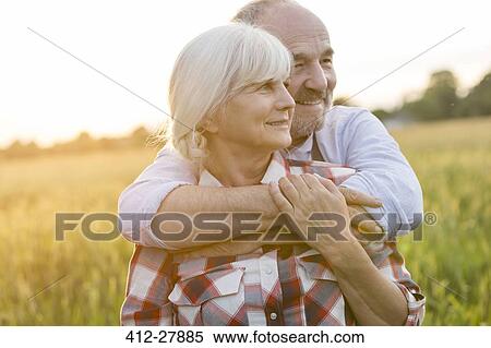 Senior couple hugging in rural wheat field View Large Photo Image Stock Photography - Senior couple hugging in rural wheat field. Fotosearch