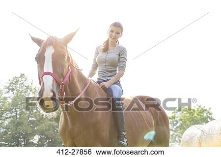 Smiling woman riding horse bareback View Large Photo Image Stock Photograph - Smiling woman riding horse bareback. Fotosearch