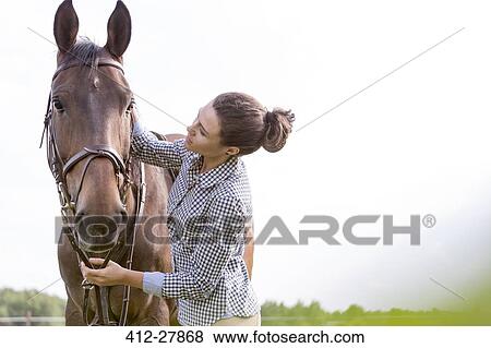 Woman petting horse View Large Photo Image Stock Photo - Woman petting horse. Fotosearch