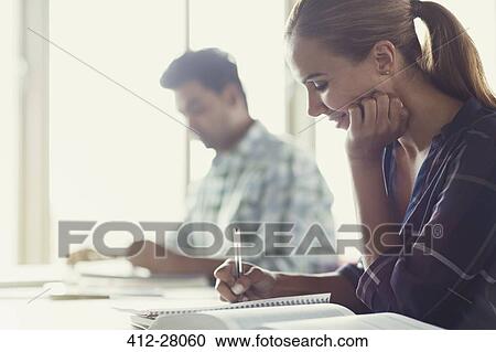 Adult education student doing homework in classroom View Large Photo Image Stock Image - Adult education student doing homework in classroom. Fotosearch
