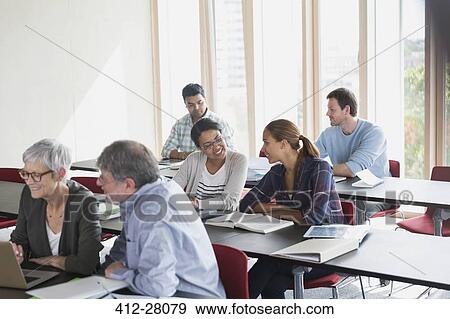 Adult education students working in pairs in classroom View Large Photo Image Stock Photo - Adult education students working in pairs in classroom. Fotosearch