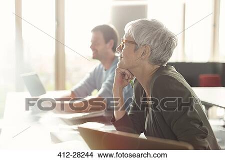 Attentive senior woman listening in adult education classroom View Large Photo Image Picture - Attentive senior woman listening in adult education classroom. Fotosearch