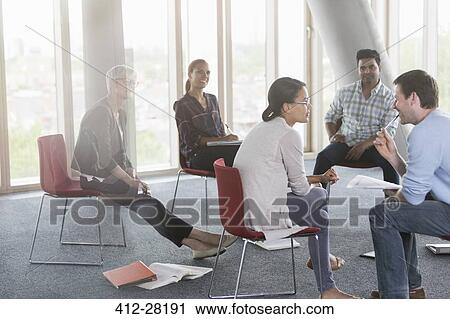 Stock Image - Business people meeting in circle. Fotosearch
