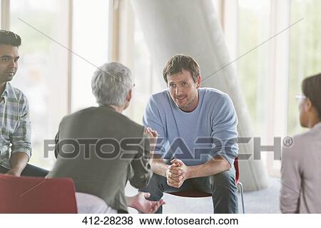 Stock Photo - Business people talking in group meeting. Fotosearch