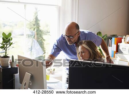 Business people working at computer in home office View Large Photo Image Stock Image - Business people working at computer in home office. Fotosearch
