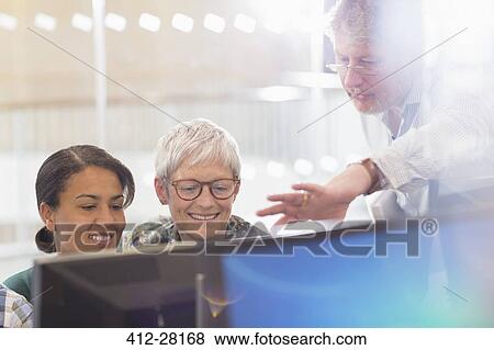 Business people working at computer in office View Large Photo Image Stock Photo - Business people working at computer in office. Fotosearch