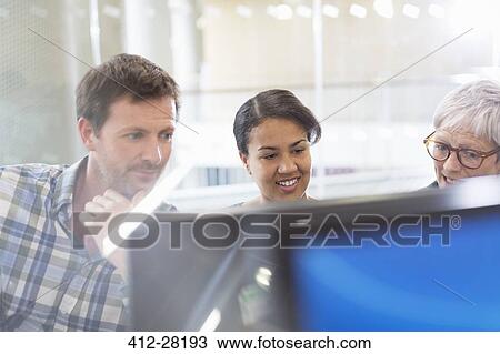Business people working at computer View Large Photo Image Stock Image - Business people working at computer. Fotosearch