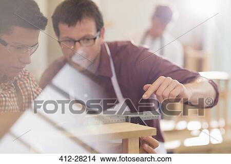Carpenters measuring wood with ruler in workshop View Large Photo Image Picture - Carpenters measuring wood with ruler in workshop. Fotosearch