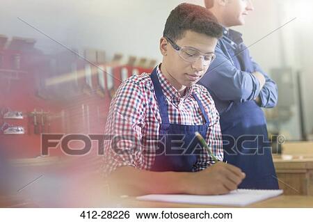 Carpentry student taking notes in workshop View Large Photo Image Stock Photograph - Carpentry student taking notes in workshop. Fotosearch