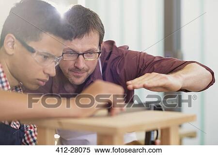 Carpentry teacher and student examining measurement View Large Photo Image Stock Photography - Carpentry teacher and student examining measurement. Fotosearch