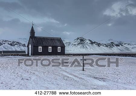 Stock Photo - Church and graveyard in snowy remote mountain landscape, Budir, Snaefellsnes, Iceland. Fotosearch