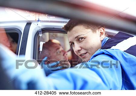 Stock Photography - Close up rescue worker tending to car accident victim. Fotosearch