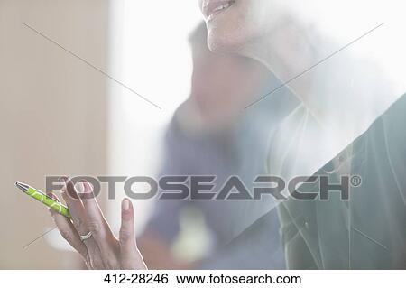 Stock Photograph - Close up senior businesswoman gesturing in meeting. Fotosearch