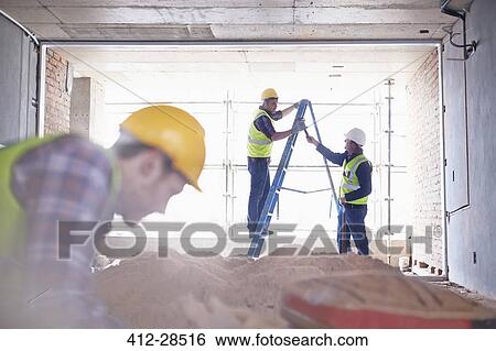 Construction worker on ladder at construction site View Large Photo Image Stock Photograph - Construction worker on ladder at construction site. Fotosearch