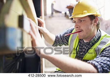 Construction worker using level tool View Large Photo Image Stock Image - Construction worker using level tool. Fotosearch