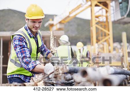 Stock Photo - Construction worker working at construction site. Fotosearch