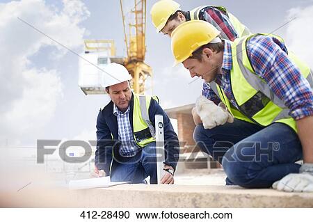 Construction workers and engineer using level tool at construction site View Large Photo Image Stock Image - Construction workers and engineer using level tool at construction site. Fotosearch