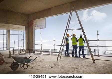 Construction workers at highrise construction site View Large Photo Image Stock Image - Construction workers at highrise construction site. Fotosearch