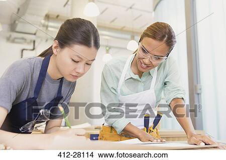 Female carpenters drafting plans in workshop View Large Photo Image Picture - Female carpenters drafting plans in workshop. Fotosearch