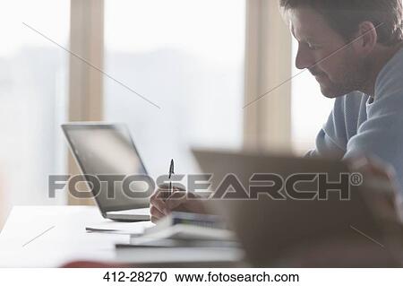 Focused businessman taking notes in meeting View Large Photo Image Stock Image - Focused businessman taking notes in meeting. Fotosearch