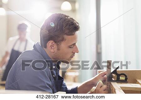 Focused carpenter working in workshop View Large Photo Image Stock Photo - Focused carpenter working in workshop. Fotosearch