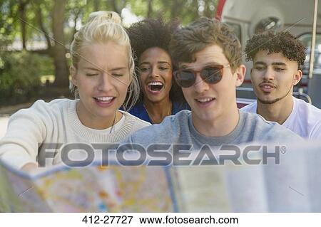 Friends looking at map on double-decker bus View Large Photo Image Stock Photo - Friends looking at map on double-decker bus. Fotosearch