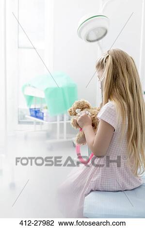 Girl using stethoscope on teddy bear in examination room View Large Photo Image Stock Image - Girl using stethoscope on teddy bear in examination room. Fotosearch