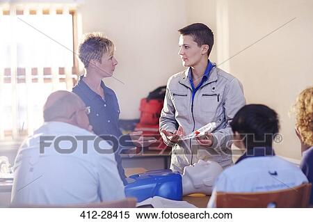 Instructor leading CPR training class View Large Photo Image Stock Photography - Instructor leading CPR training class. Fotosearch