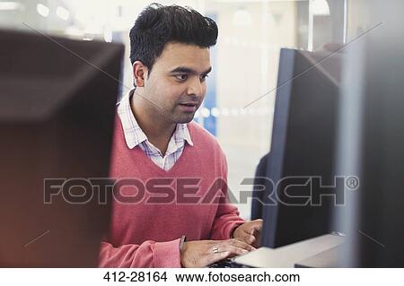 Man typing at computer in adult education classroom View Large Photo Image Picture - Man typing at computer in adult education classroom. Fotosearch