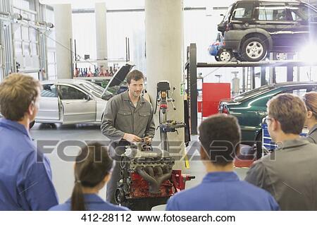 Mechanic explaining car engine to students in auto repair shop View Large Photo Image Stock Image - Mechanic explaining car engine to students in auto repair shop. Fotosearch