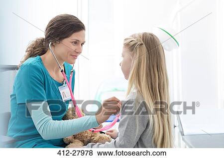 Stock Photo - Nurse using stethoscope on girl patient in examination room. Fotosearch