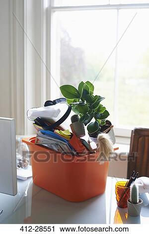 Office belongings in bin on desk View Large Photo Image Stock Image - Office belongings in bin on desk. Fotosearch