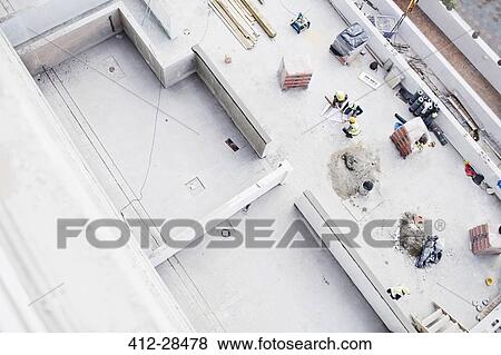 Overhead view of construction workers at construction site View Large Photo Image Stock Photo - Overhead view of construction workers at construction site. Fotosearch