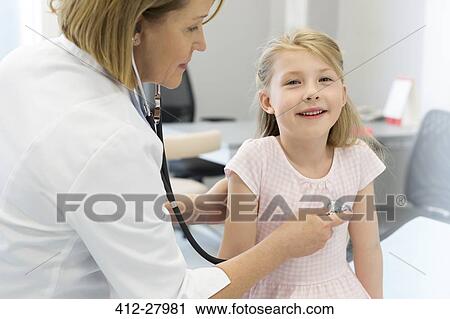 Pediatrician using stethoscope on girl patient in examination room View Large Photo Image Stock Image - Pediatrician using stethoscope on girl patient in examination room. Fotosearch