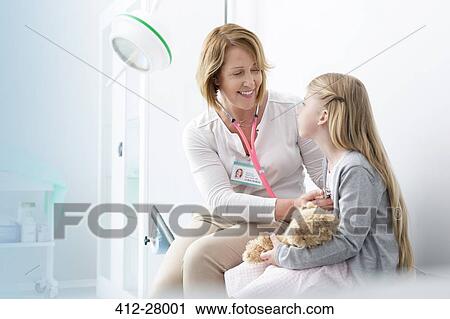 Pediatrician using stethoscope on girl patient in examination room View Large Photo Image Stock Image - Pediatrician using stethoscope on girl patient in examination room. Fotosearch
