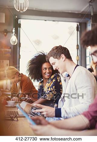 People reading magazine and using digital tablet in cafe View Large Photo Image Stock Image - People reading magazine and using digital tablet in cafe. Fotosearch